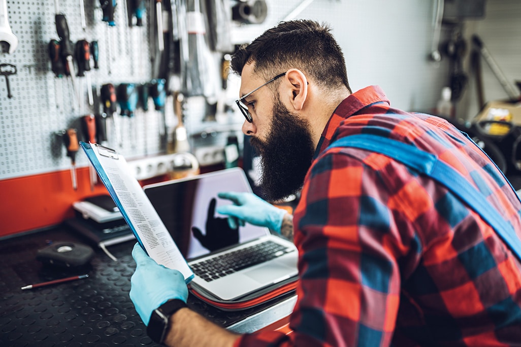 Technician loads laptop with vehicle diagnostics