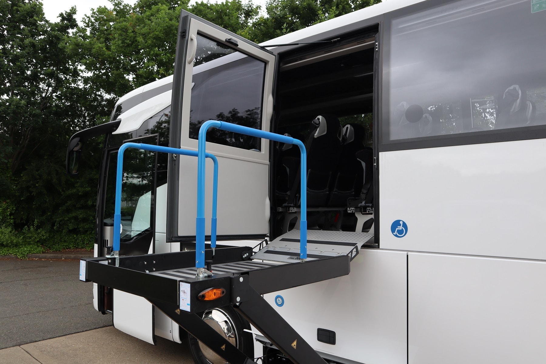 Wheelchair user lift on side of coach