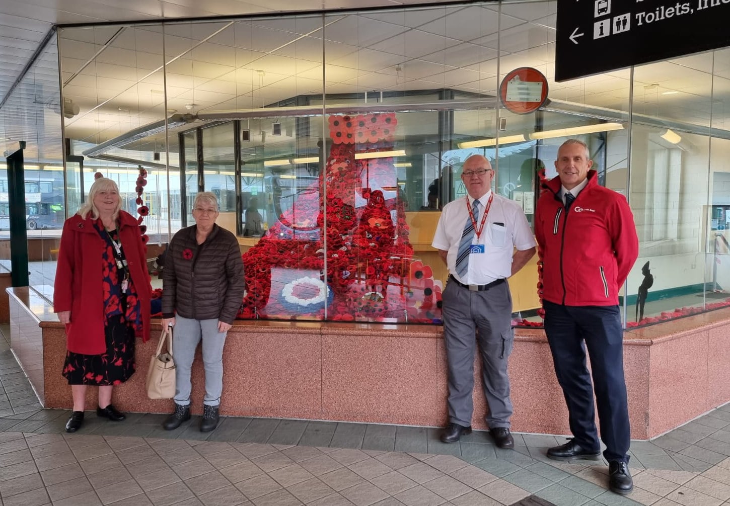 GNE Poppy display - two customers who knitted poppies for the display, John Gordon (Bus Station Supervisor), Neil Kennedy (Driver)_