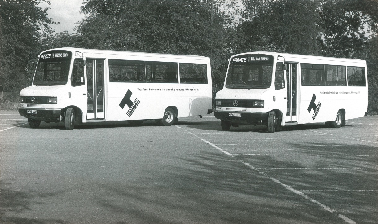photo of two Uno minibuses back when the company was a universityshuttle