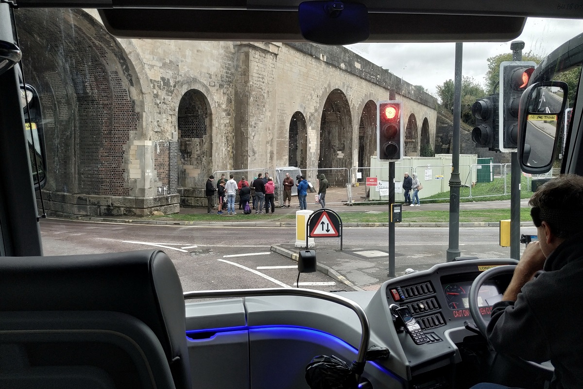 Coach driver waiting at traffic lights