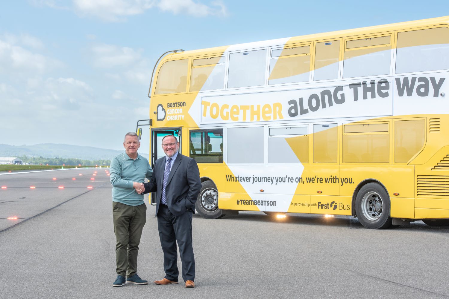 Martin Cawley, CEO of Beatson Cancer Charity, shakes hands with Graeme Macfarlan, Commercial Director for First Bus Scotland