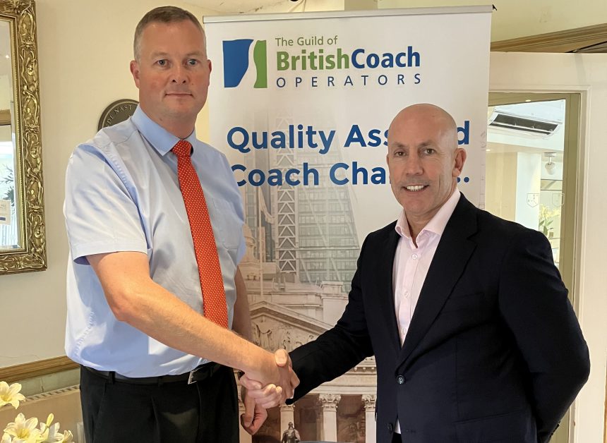 photo of Phil Hitchen of Belle Vue Manchester, right, with Anthony Winson, chairman of the Guild of British Coach Operators