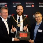 Councillor Rob Yates, Town Mayor of Margate, presents the Vehicle of the Year award at the Self-Driving Industry Awards to Peter Stephens, Public Affairs Director at Stagecoach, and Matt Lawrence, Fleet Business Development Director at Alexander Dennis