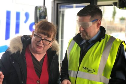 Eileen of RNIB Scotland guiding a trainee driver with sim specs on mcgills (1)