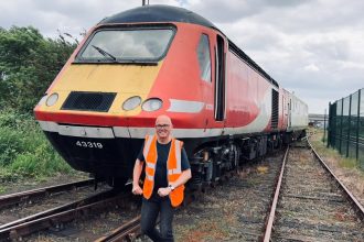 Andrew Wickham standing in front of a HST power car