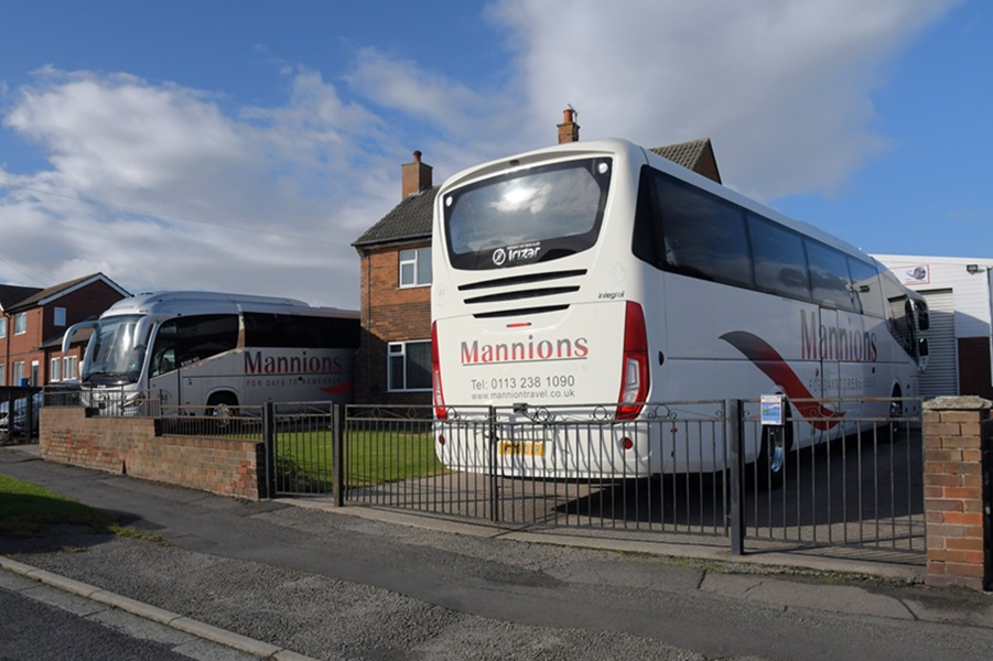 Two Irizar coaches parked on a drive